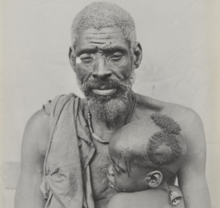 A man and child from Igbariam, c. 1911.