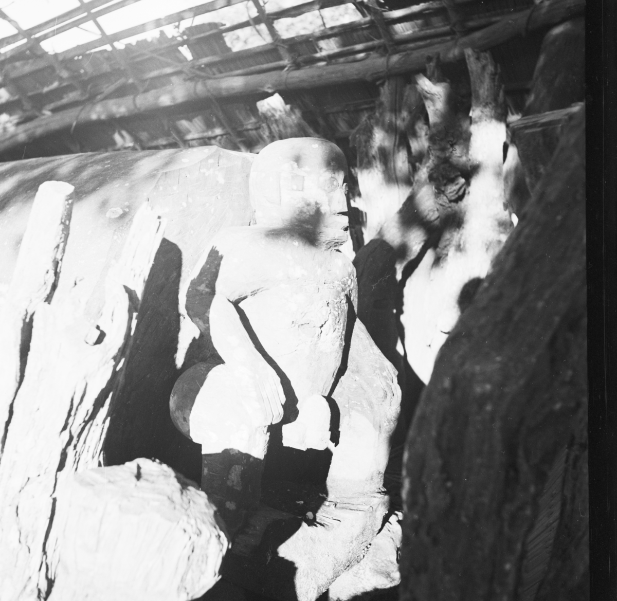 The other end of the same Ikoro drum depicting a seated male figure. Photograph by Gwilliam Iwan Jones, 1932-1939, Ohafia, Nigeria. Image source: Jones Collection.