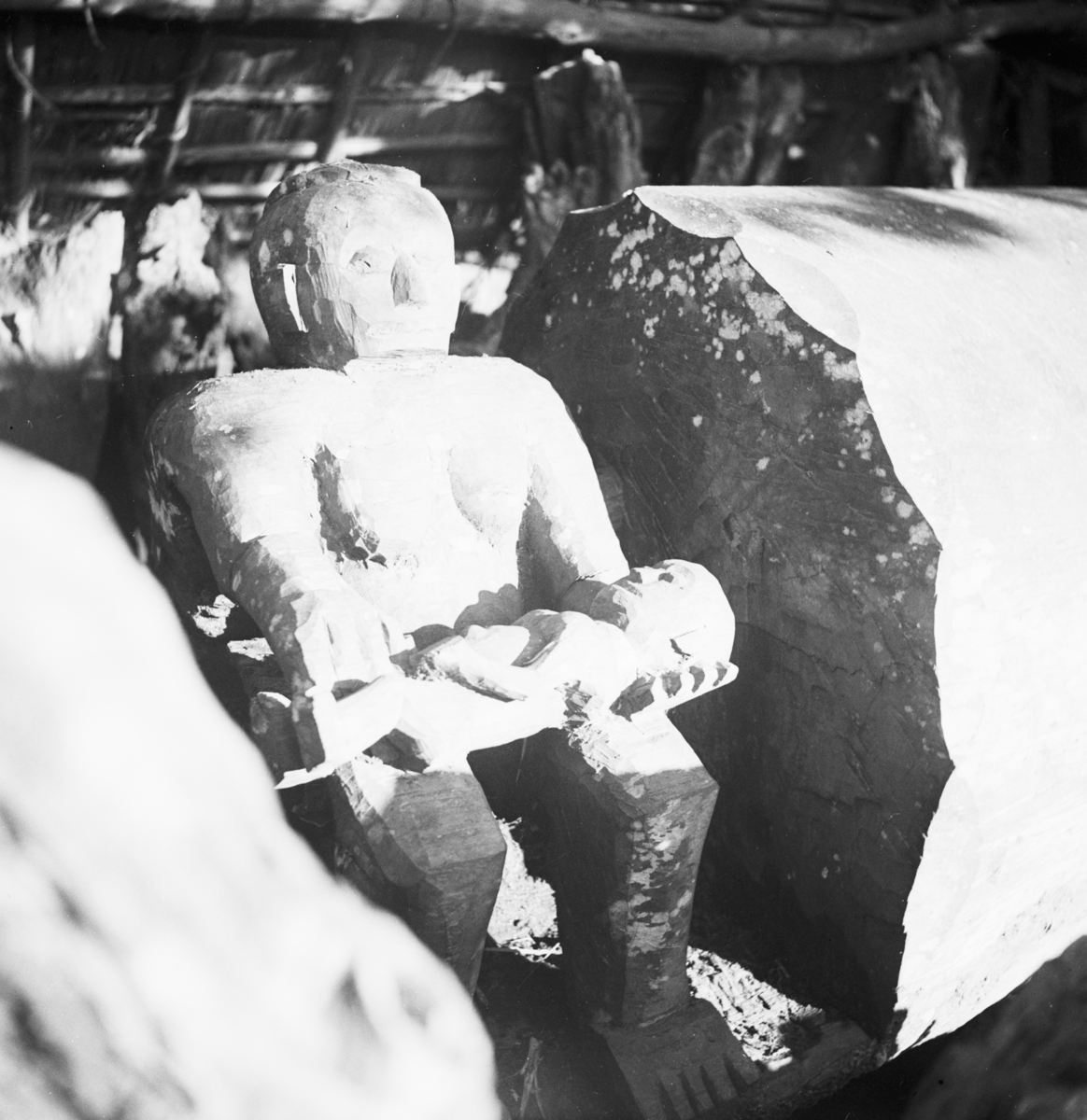 A Wooden Ikoro Drum from Ohafia with a Female Figure Holding a Baby. 1930s