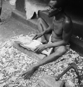 A wood carver carving an Ikenga figure, Nri-Awka Igbo. c. 1930