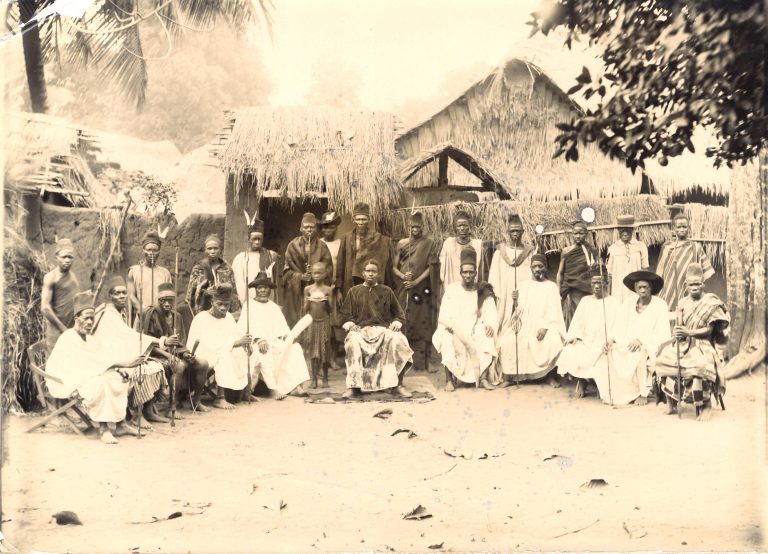 Group portrait of Igbo men with ceremonial attire, 1900-1915.