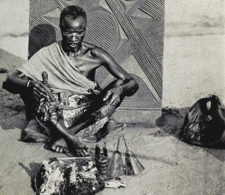 A Dibia with his tools, 1921. Source: Basden, G. T. Among the Ibos of Nigeria. Philadelphia: J.B. Lippincott, 1921, pg. 160.